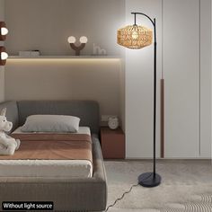 a bed room with a neatly made bed and a floor lamp