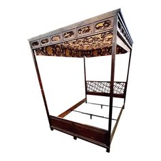 a canopy bed with an intricate wooden frame and iron work on the top, against a white background