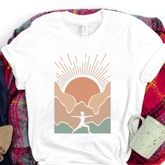 We love outdoor yoga, celebrating our inner strength in nature! This is a soft and comfy tee with a hip design for all yogis. T-SHIRT MATERIALS Solid colors: 100% airlume combed and ring-spun cotton Heather colors: 52% airlume combed and ring-spun cotton, 48% polyester Athletic Heather: 90% airlume combed and ring-spun cotton, 10% polyester Our Bella + Canvas style 3001, is a popular unisex style that is eco friendly and known for its durability. This tee is relaxed fit more narrow than a tradit Yoga Tshirt Design, Outside Yoga, Nature Yoga, Shirt Drawing, Yoga Design, Embroidery Download, Yoga Shirt, Yoga Instructor, Outdoor Yoga