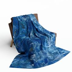 a blue blanket sitting on top of a wooden chair