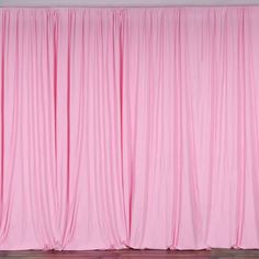 a pink curtain with wooden floors in front of it