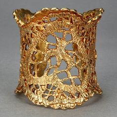 Features: - 100% Authentic CHRISTIAN LACROIX. - Gilt textured wide cuff in gold tone. - Detailed Christian Lacroix emblems in openwork lace pattern. - Signed Christian Lacroix CL Made in France. - Excellent vintage condition. Measurements: Height: 2.75 inches (7.7 cm) Inner Circumference: 6.69 inches (17.5 cm) includes opening **This cuff bracelet will be shipped via DHL Express Shipping with tracking number. Please convo me for any queries and additional photos. Thank you for visiting. Other Fe Gold Cuff Bracelet With Intricate Design, Gold Filigree Cuff Bracelet As Gift, Unique Gold Cuff Bracelet With Intricate Design, Unique Gold Wide Band Cuff Bracelet, Christian Lacroix Jewelry, Wax Carving Jewelry, Lace Cuff Bracelet, Gold Car, Lace Cuffs