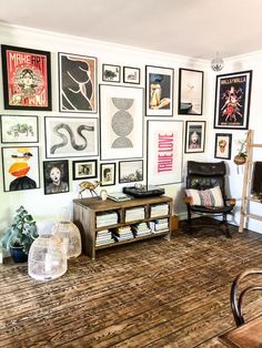 a living room filled with furniture and pictures on the wall