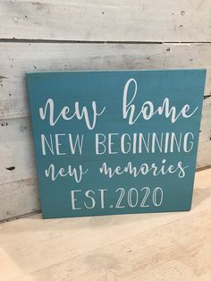 a wooden sign that reads new home, new beginning, new memories est 2020