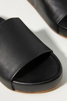 Seamlessly fusing comfort and style, this leather pair is a warm-weather essential you'll love now and for years to come. | Pelican Slide Sandals by beek in Black, Women's, Size: 11, Leather/Rubber at Anthropologie Casual Leather Slides With Textured Sole, Leather Sandals With Leather Lining For Everyday, Summer Leather Footbed Sandals With Rubber Sole, Leather Slides With Textured Footbed For Beach, Leather Slide Footbed Sandals For Vacation, Leather Flat Footbed Sandals For Vacation, Casual Leather Footbed Sandals With Textured Sole, Leather Slides With Leather Lining For Beach, Everyday Leather Slip-on Slides