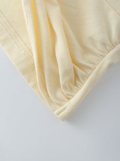 The Knot Tee-Vanilla is the perfect addition to any wardrobe. Crafted from lightweight materials, it is comfortable and easy to wear, yet durable and soft. Its subtle creamy vanilla color makes it both timeless and stylish. Cream Solid Color Top For Spring, Cream Stretch Tops For Loungewear, Cream Summer Loungewear Tops, Off White Spring Loungewear Top, Off White Cotton Loungewear Tops, Off White Cotton Tops For Loungewear, Off White Cotton V-neck Top, Cream Cotton Tops For Loungewear, Vanilla Color