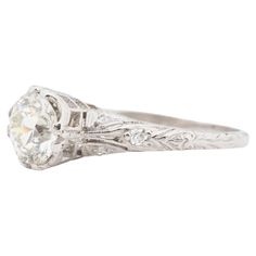 an antique diamond engagement ring with filigrees