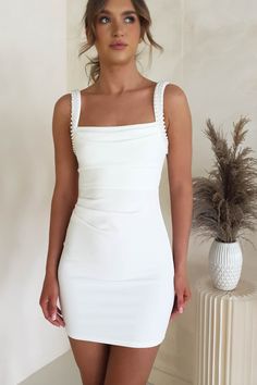 Highlights Elegant bodycon mini Beautiful pearl straps Gathered waistline Soft, stretchy fabric We would recommend wearing nude underwear with this dress Sizing The model is 5'10 and wears UK size 8 / S / US size 4 Fit & Fabric Made from 100% Polyester Rear zip Not lined True to size Length from top of shoulder to