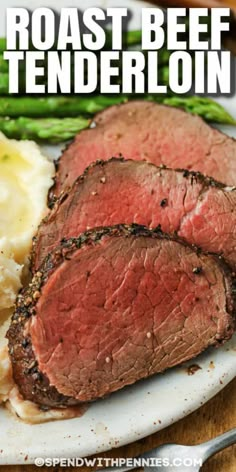 roast beef tenderloin on a plate with mashed potatoes and asparagus