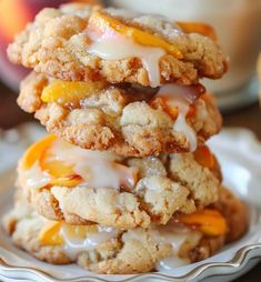 three cookies stacked on top of each other with icing and peaches around them