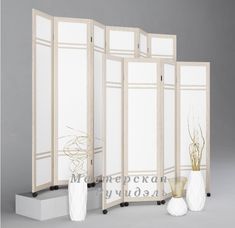 a room divider with three vases on each side