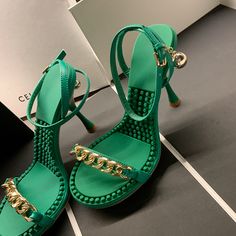 Looking for a summery and chic pair of heels? These green sandals are perfect! They feature an ankle strap and gold chain detailing that add a touch of glamour. Whether you're headed to the beach or a summer wedding. these heels will have you looking your best. Upper: Leather Lining: Leather Outsole: TPR Toe: Open Toe Closure: Buckle Strap Color: Black. Green. Purple is_handmade: Yes The above measurement is based on size 6. with one size larger. 0.5cm wider. Beach Sandals With Chain Strap For Summer, Summer Sandals With Chain Strap And Open Toe, Green Ankle Strap Sandals For Party, Gold Sandals With Chain For Summer, Chic Chain Sandals For Spring, Chic Open Toe Sandals With Chain Detail, Summer Party Sandals With Chain Strap, Open Toe Heels With Chain Strap For Party, Party Open Toe Heels With Chain Strap