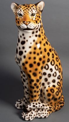 a ceramic figurine of a sitting leopard