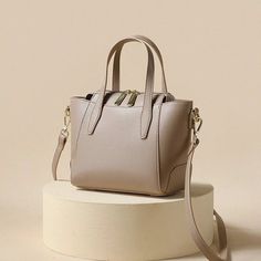 Indulge in sophistication with our Light-Toned Leather Tote Bag. Crafted for the modern woman, this elegant handbag adds a touch of refined style to any occasion. The light colors elevate the chic and timeless appeal, making it the perfect accessory for your graceful ensemble. Lining Material: Polyester Main Material: Split Leather Interior Slot Pocket Handbag Size (inches): 7.87x6.7x4.3 inches Handbag Size (cm): 20x17x11 cm Chic Cream Satchel Box Bag, Elegant Handheld Solid Color Shoulder Bag, Elegant Large Capacity Solid Shoulder Bag, Elegant Everyday Tote Evening Bag, Elegant Cream Satchel Evening Bag, Modern Beige Evening Bag For Everyday Use, Elegant Beige Evening Bag For Everyday, Formal Beige Tote Evening Bag, Feminine Beige Leather Bag