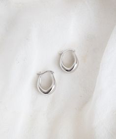 Elevate your style with our minimal Point Huggie Hoops. With a subtle tear-drop silhouette, these huggies are unique enough to feel like an understated statement and versatile for everyday wear. Trust us; you won't want to take them off. Minimal Silver Jewelry, Earring Stacks, Lisa Johnson, Earrings Minimal, Earrings Aesthetic, Silver Jewels, Genuine Leather Bags, Microfiber Cloth, Tear Drop