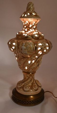 an ornate lamp is lit up on a white background