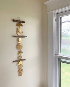 there is a wall decoration made out of wood and metal discs hanging on the wall