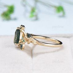 a gold ring with an oval cut green tourmaline