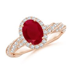 an oval shaped ruby and diamond ring in 18k rose gold with diamonds around the band