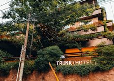 the trunk hotel is located on top of a steeple with plants growing up it's side