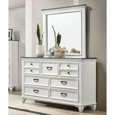 a white dresser and mirror in a room