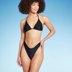 Scoop-front thong bikini bottom from Wild Fable™ in black. Made from soft fabric with spandex and full lining for stretchy comfort in and out of the water. Designed in thong style with low rise and extra-high leg for a chic, flattering look. If you're not satisfied with any Target Owned Brand item, return it within one year with a receipt for an exchange or a refund. Wild Fable™: A look for every story. Sleek Triangle Top Swimwear For Poolside, Sleek Solid Color Triangle Top Swimwear, Sleek Triangle Top Swimwear, Bra Friendly, Sleek Triangle Top Swimwear Bra Friendly, Sleek Bra-friendly Triangle Top Swimwear, Black T-back Beach Bottoms, Swim Suit Bottoms, Swim Bottoms, High Leg