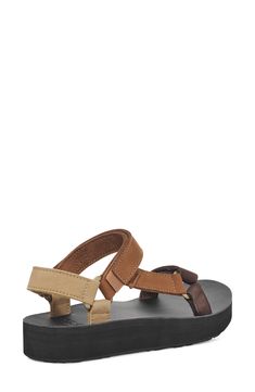 An edgy mash-up of the brand's Original Universal and Flatform Universal sandals, this leather version delivers sporty style with an upgraded look. 1 1/4" heel; 1" platform; 1/4" slope (size 9) Adjustable straps with hook-and-loop closures EVA foam-cushioned footbed Leather upper and lining/rubber sole Imported Casual Leather Sport Sandals For Outdoor, Outdoor Leather Sport Sandals With Leather Footbed, Brown Leather Sport Sandals With Round Toe, Brown Casual Sport Sandals With Double Strap, Sporty Leather Sport Sandals For Outdoor, Casual Sport Sandals With Leather Footbed And Ankle Strap, Casual Strapped Leather Sandals, Brown Synthetic Sandals For Everyday Use, Brown Synthetic Sandals For Everyday