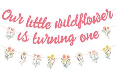 a banner that says our little wildflower is turning one