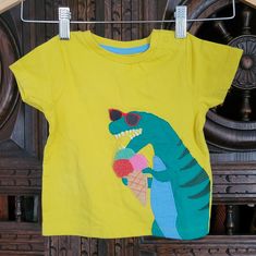 Sunny Yellow Graphic T-Shirt With An Applique Of A Dinosaur In Sunglasses Eating Icecream. New In Original Packaging, Didn't Come With Tags. Smoke Free Home. Cute Yellow T-shirt For Playtime, Green Dinosaur Print Top For Spring, Green Dinosaur Print Tops For Spring, Short Sleeve Dinosaur Print Tops For Playwear, Playful Yellow Top With Cartoon Print, Yellow Cartoon Print T-shirt For Summer, Green Cotton Dinosaur Print Tops, Yellow Playful Tops For Playtime, Green T-shirt For Summer Playwear