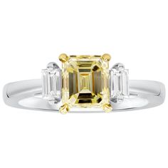 A sophisticated engagement ring, featuring a 1.63 carats emerald cut yellow diamond certified by GIA as Fancy Light Yellow color and VS1 clarity, set on a four prong yellow gold basket. Flanked by two vertical baguette cut diamonds weighing 0.33 carat total. Finely made with a platinum mounting. Size 5.75 US, resizable upon request.  Roman Malakov is a custom house, specializing in creating anything you can imagine. If you would like to receive a special quote on a custom piece, please message o Yellow Diamonds Engagement, Light Yellow Color, Yellow Diamond Engagement Ring, Canary Diamond, Timeless Engagement Ring, Fancy Light, Emerald Cut Diamond Engagement, Three Stone Diamond Ring, Yellow Engagement Rings