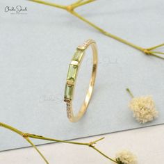 a close up of a ring on a table with flowers and dried grass in the background