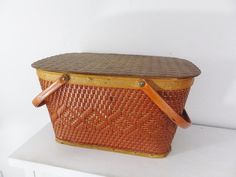 a brown basket sitting on top of a white table