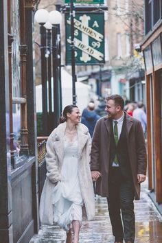 a man and woman are walking down the street