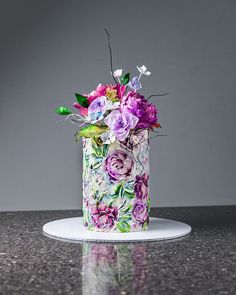 there is a colorful cake with flowers on it