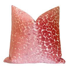 an orange and pink pillow with spots on it's back side, against a white background