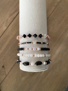 a stack of bracelets sitting on top of a white napkin