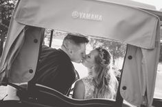 a bride and groom kissing in a horse drawn carriage