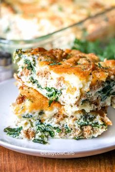 a white plate topped with lasagna casserole next to a glass dish