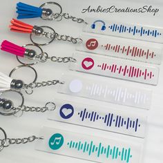 four key chains with music notes on them