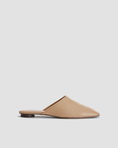 Classic Slip-on Mules For Everyday, Everyday Leather Slip-on Slippers, Leather Footbed Slip-on Mules For Everyday, Everyday Slip-on Flat Heel Mules, Leather Slippers For Everyday Spring Wear, Everyday Slip-on Mules With Flat Heel, Everyday Flat Heel Slip-on Mules, Modern Closed Toe Calf Leather Mules, Leather Slip-on Mules For Spring