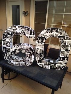 a large number made out of photos on a table with a window in the background