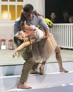 a man and woman are dancing on stage