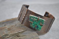 "Handcrafted rustic copper cuff created by hammering, annealing, form folding, drilling, filing, and adding an antique patina. A flat turquoise layer stone has been attached through the use of prongs The piece has been tumbled for polishing. The inside of this bracelet has been treated with acrylic to prevent tarnish on your skin.  I love making these bracelets and hope you will enjoy wearing one too! INSIDE FIT:  The inner circumference is 6.75\" with a 1\" gap  17.2 cm  with gap 2.54 cm This cuff would be considered a medium size. 1 1/4\" wide   3.17 cm  Sizing: Cuffs have approximately a 1\" - 1 1/4\" opening and this can be adjusted either way with slight pressure for your custom fit. This allows you to use the gap in the bracelet for putting on and taking off.  Your cuff will be place Rustic Green Adjustable Jewelry, Hand Forged Rust Copper Jewelry, Rust Colored Hammered Copper Jewelry, Adjustable Vintage Hammered Jewelry, Vintage Adjustable Hammered Jewelry, Bronze Bohemian Jewelry With Patina, Bohemian Bronze Jewelry With Patina, Artisan Rust-colored Metal Jewelry, Bohemian Bronze Patina Jewelry