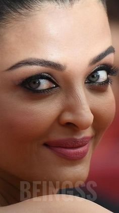 a close up of a woman with blue eyes