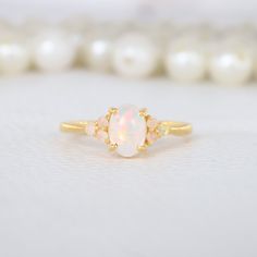 Oval Shape White Opal Ring 10K Solid Gold Engagement Ring Opal Cluster Bridal Ring October Birthstone Gold Jewelry Anniversary Gift For Wife Description: Main Stone - Opal ( Lab created ) Stone Size - 7 x 5 MM / 2 MM Stone color -Fire Opal Stone shape - Oval / Round Birthstone - October Finishing- Excellent feel free to contact me if you have any questions  Gemstone color may slightly vary from listed image due to the nature of all natural gemstone or different monitor settings TURNAROUND TIME Y Gold Opal Birthstone Wedding Ring, White Opal Ring With Accent Stones In 14k Gold, White 14k Gold Crystal Ring For Anniversary, 14k Gold Opal Ring With Gemstone Accents For Promise, White Crystal Ring In 14k Gold For Anniversary, Delicate White Jewelry With Center Stone, Elegant White Multi-stone Birthstone Ring, Dainty Wedding Birthstone Ring With Gemstone Accents, Heirloom Opal Ring With Gemstone Accents For Wedding