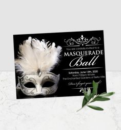 a masquerade ball party card with a white mask and feathers on the front