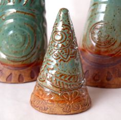 three ceramic cones are sitting next to each other