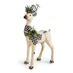 a white and black reindeer figurine with a checkered scarf on it's head