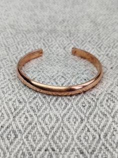 This Hand Forged 100% Pure Copper Bracelet is a stunning piece of jewelry that boasts of solid copper construction, making it ideal for anyone looking for an Arthritis Relief Bracelet. It features a wrap-style setting that is handmade and crafted in Nepal by Shaney Entreprise, a reputable brand in the industry. The cuff-style bracelet is perfect for both men and women and comes with a copper purity of 100%. The bracelet comes in a beautiful copper color, and it has no stones, making it an excell Gold Electroformed Bracelets For Gift, Hammered Rose Gold Copper Jewelry, Rose Gold Copper Bangle Cuff Bracelet, Rose Gold Copper Cuff Bangle, Rose Gold Copper Bangle As Gift, Hand Forged Copper Bangle Bracelet, Hammered Copper Bangle Bracelets, Hammered Copper Bangle Bracelet, Handmade Copper Bangle Bracelets