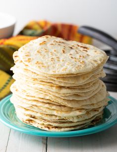 a stack of flat bread on a blue plate